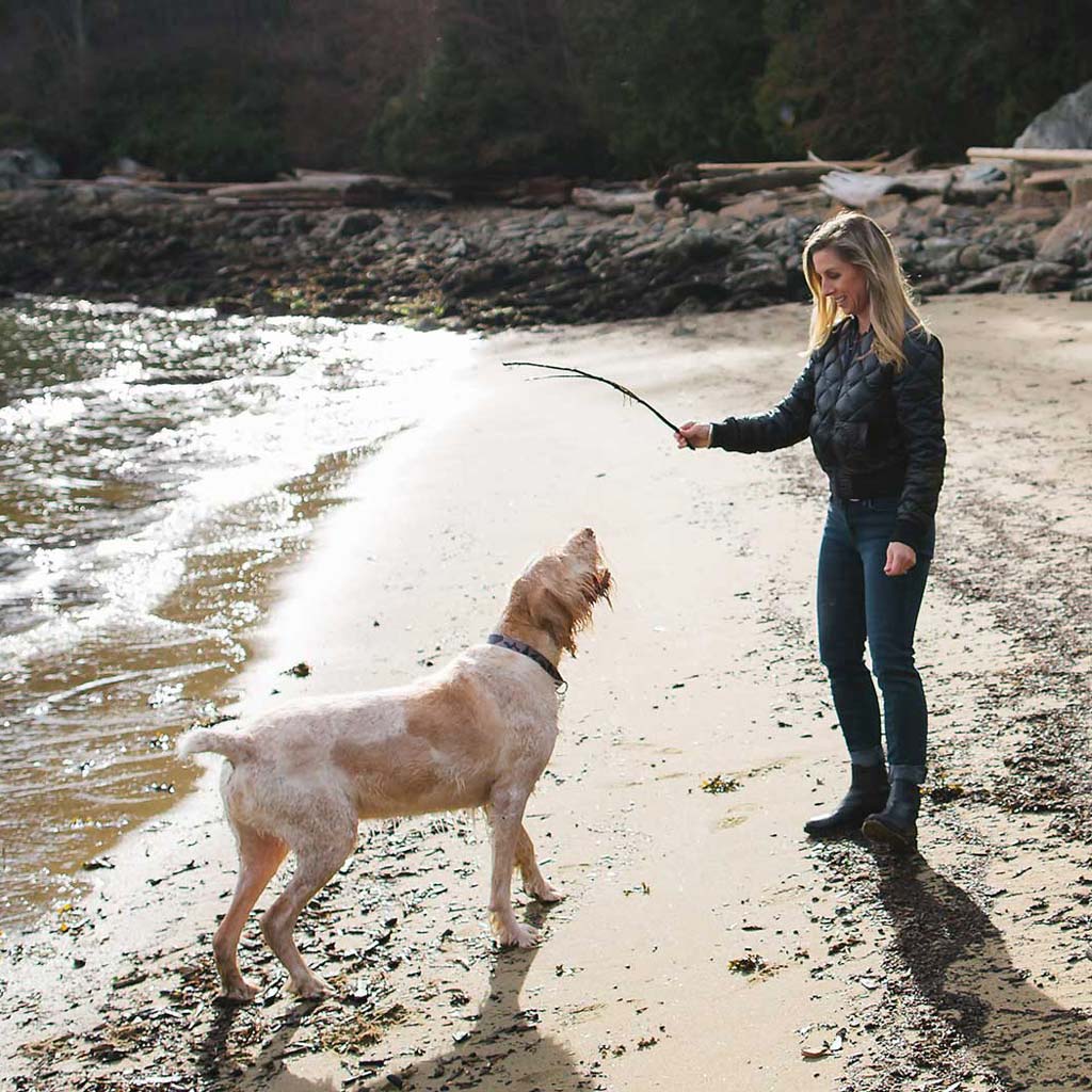 fox and aikins beach side view woman with her dog